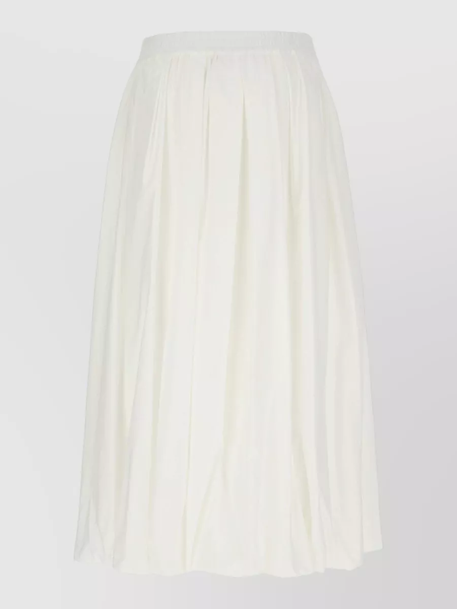 Weekend Max Mara Cotton pleated midi skirt — The soft ivory pleated midi keeps the outfit in a clean, minimalist-preppy register, echoing the tee’s lightness while giving feminine movement without competing with its black-and-white graphic.
