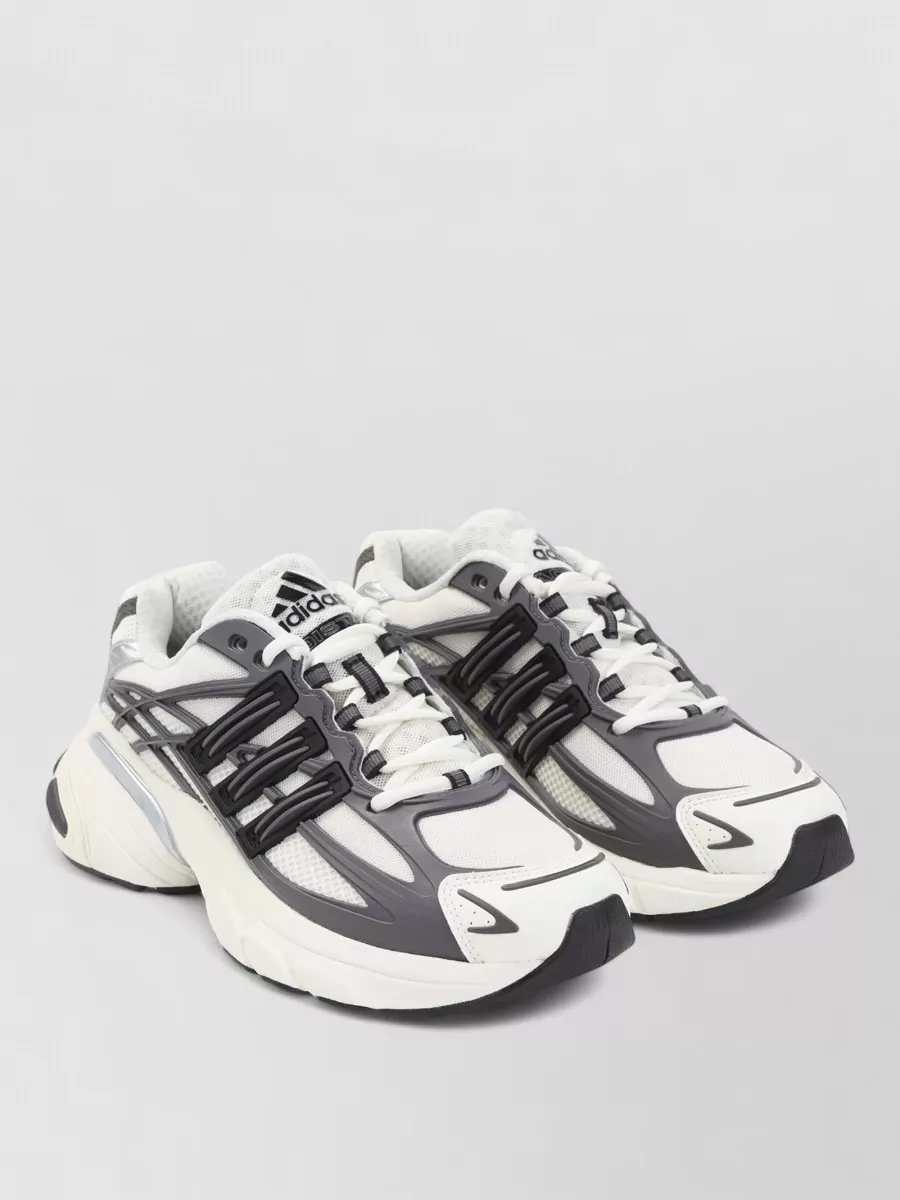 Adidas Mesh low-top sneakers — The Adidas runner in off white and charcoal hits the same understated sport energy as the jacket and pants, with a neutral palette that slots into the monochrome story without stealing focus.