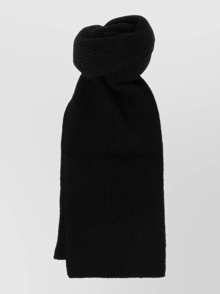 Dries Van Noten Alpaca wool ribbed scarf — The Dries Van Noten black ribbed scarf deepens the monochrome top half, adds winter practicality, and layers seamlessly with the half-zip without breaking the minimalist palette.
