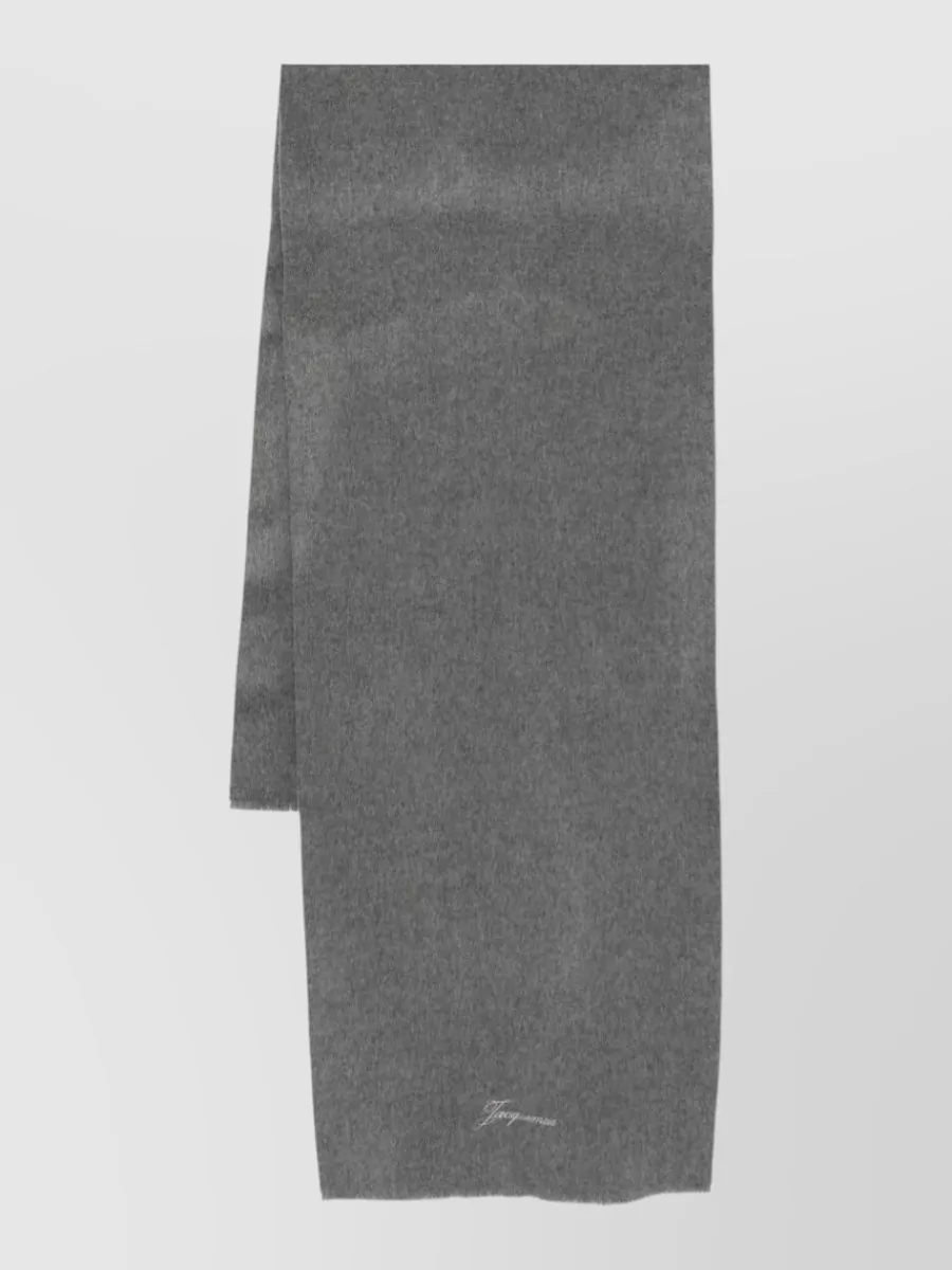 Jacquemus Cashmere wool scarf — The Max Mara charcoal scarf layers seamlessly into the grey-and-navy story, adding warmth and texture without disturbing the restrained, monochrome mood.