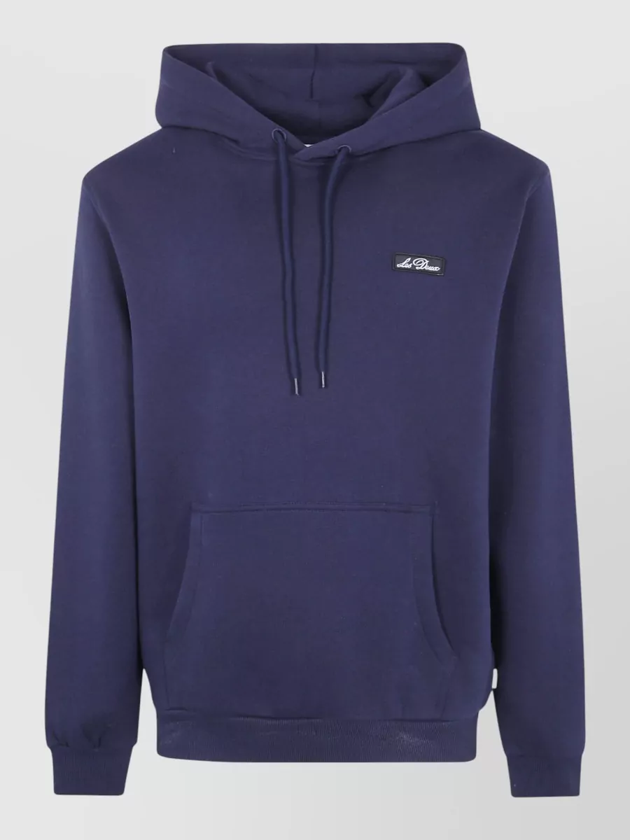 Les Deux Cotton hoodie — The navy hoodie nests tonally under the navy shirt-jacket for a clean, modern prep-sport mix that keeps the outfit casual yet considered for fall and winter.