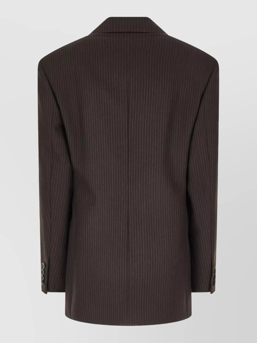 Saint Laurent Suit jacket — The Saint Laurent single-breasted pinstripe blazer in a deep charcoal-brown harmonises with the trouser’s charcoal flannel while keeping the stripe subtle and the formality at a sharp boardroom-to-evening level.