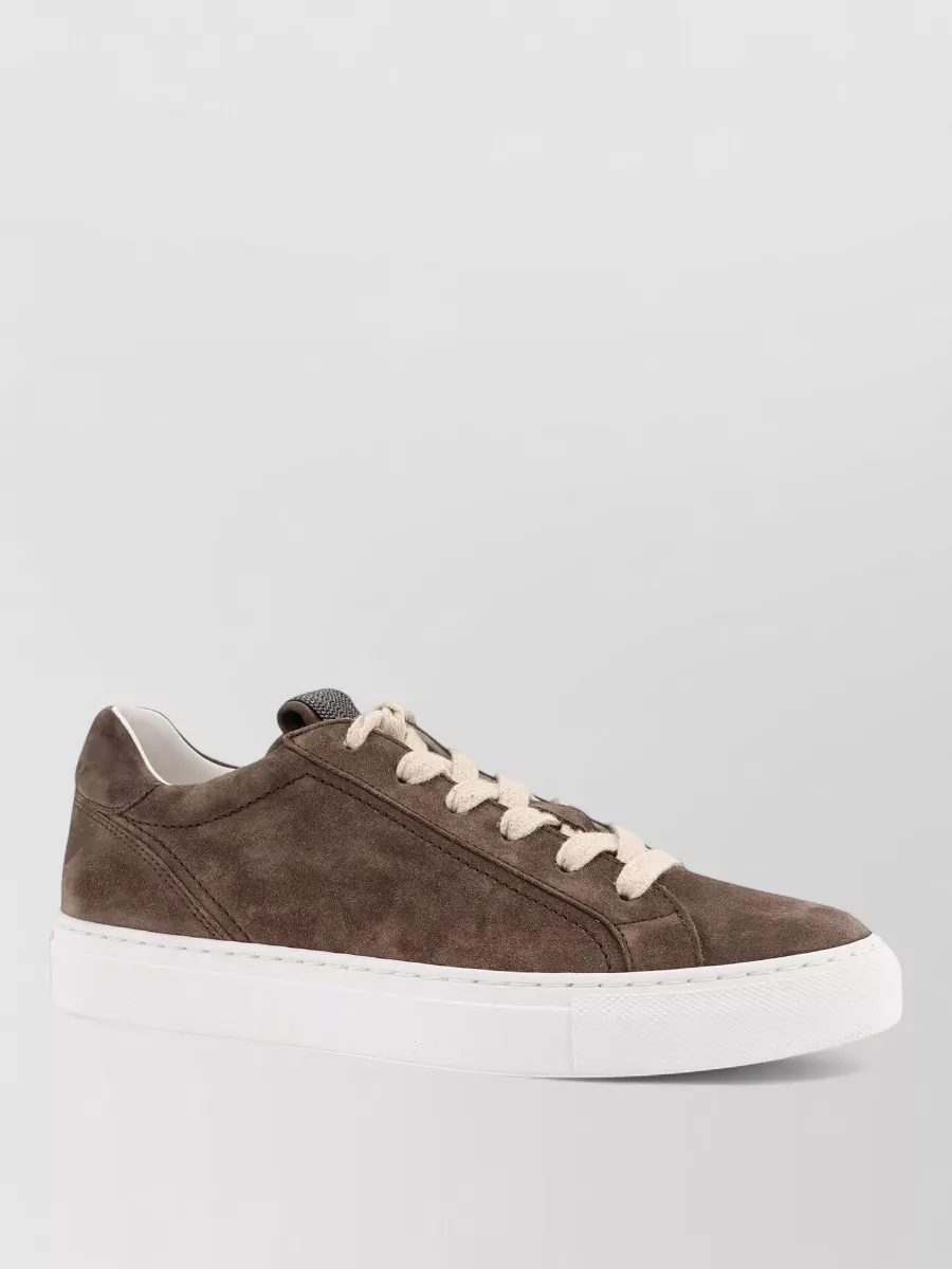 Brunello Cucinelli Suede leather low-top sneakers — The taupe suede low-top sneaker is refined yet relaxed, echoing the gilet’s quiet luxury and the dress’s sand tone while keeping the look modern and off-duty rather than overly formal.