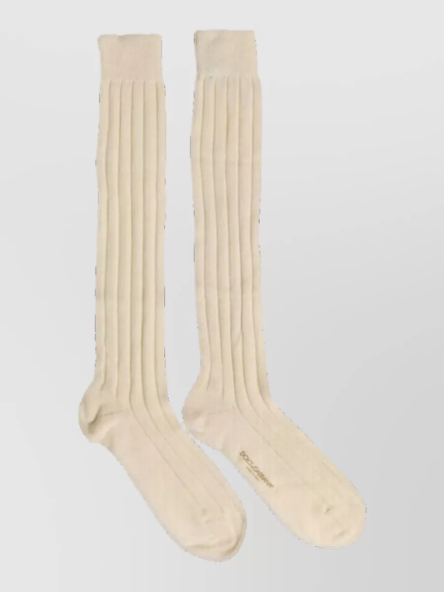 Dolce&Gabbana Wool knee-high socks — The cream Dolce&Gabbana crew socks subtly pick up the tank’s light tone and tie into the sneakers’ cream detailing, keeping the palette tight while adding a small touch of quiet branding.