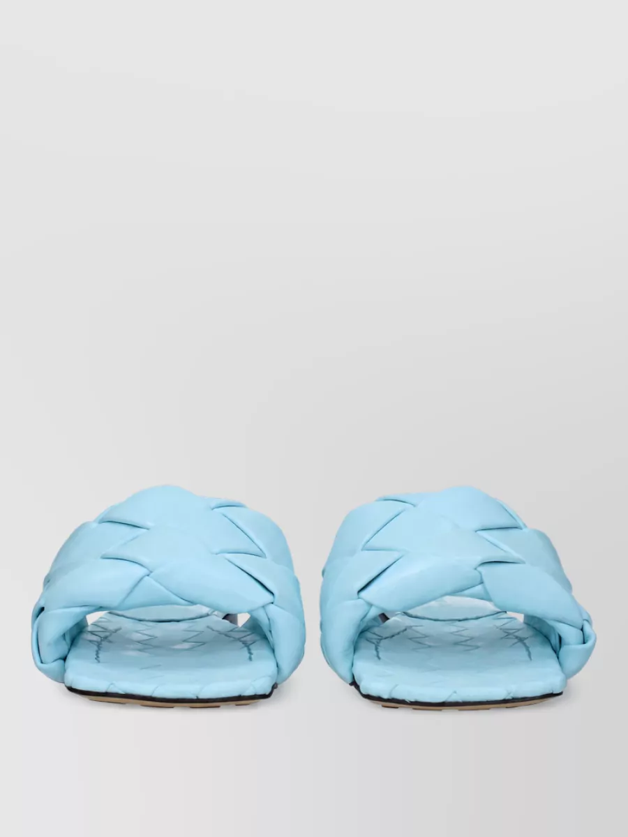 Bottega Veneta Leather sandals — The flat ice-blue Bottega slides mirror the cool tones of the shorts and stay relaxed and boho, giving a low, easy line that feels right for warm-weather city or resort days.