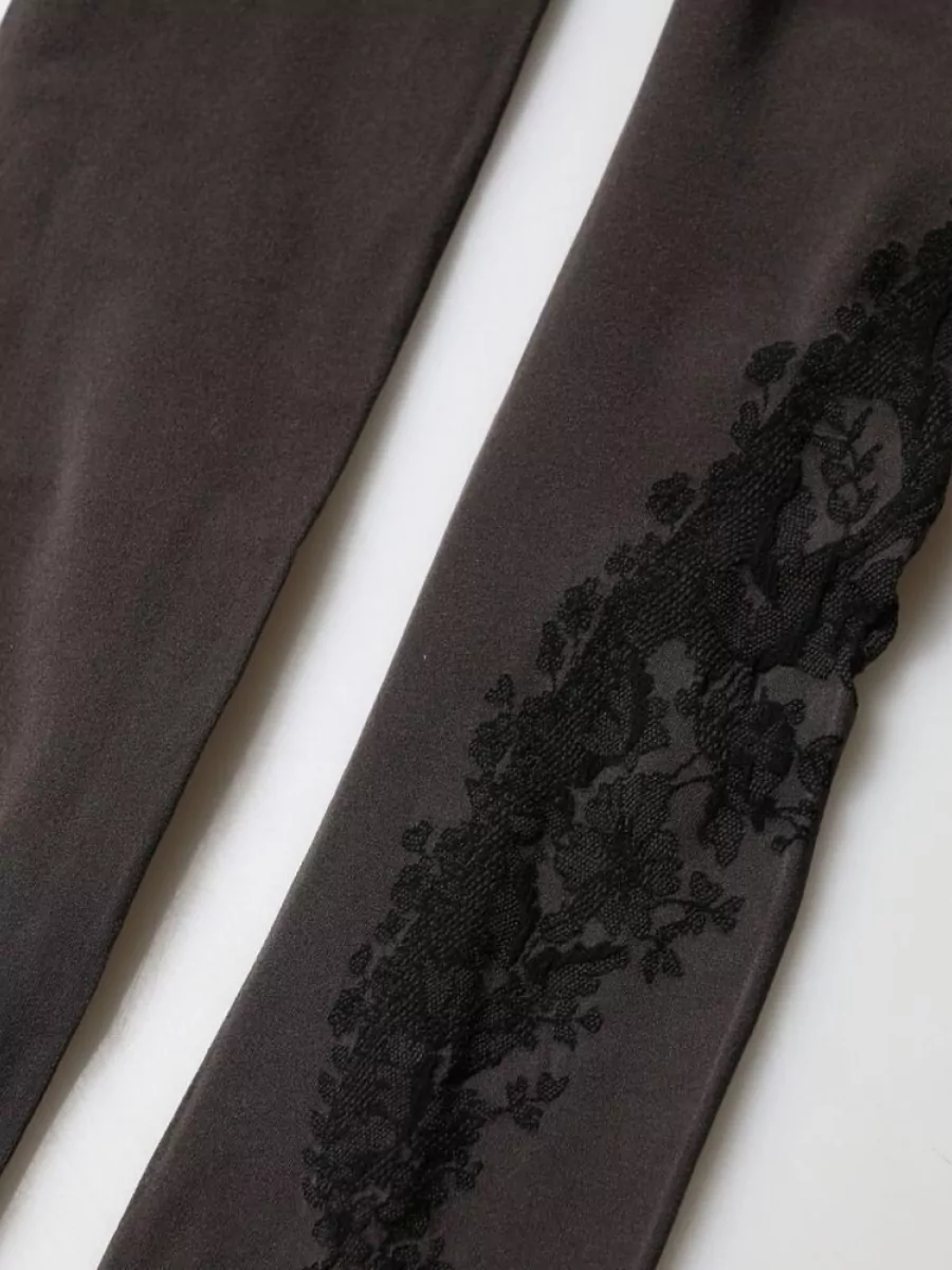 Dolce&Gabbana Nylon tights — The Dolce&Gabbana lace-paneled leggings echo the jumper’s dark lace and charcoal tones, keeping the y2k romantic mood cohesive while balancing the regular-fit top with a sleek, leggy line.