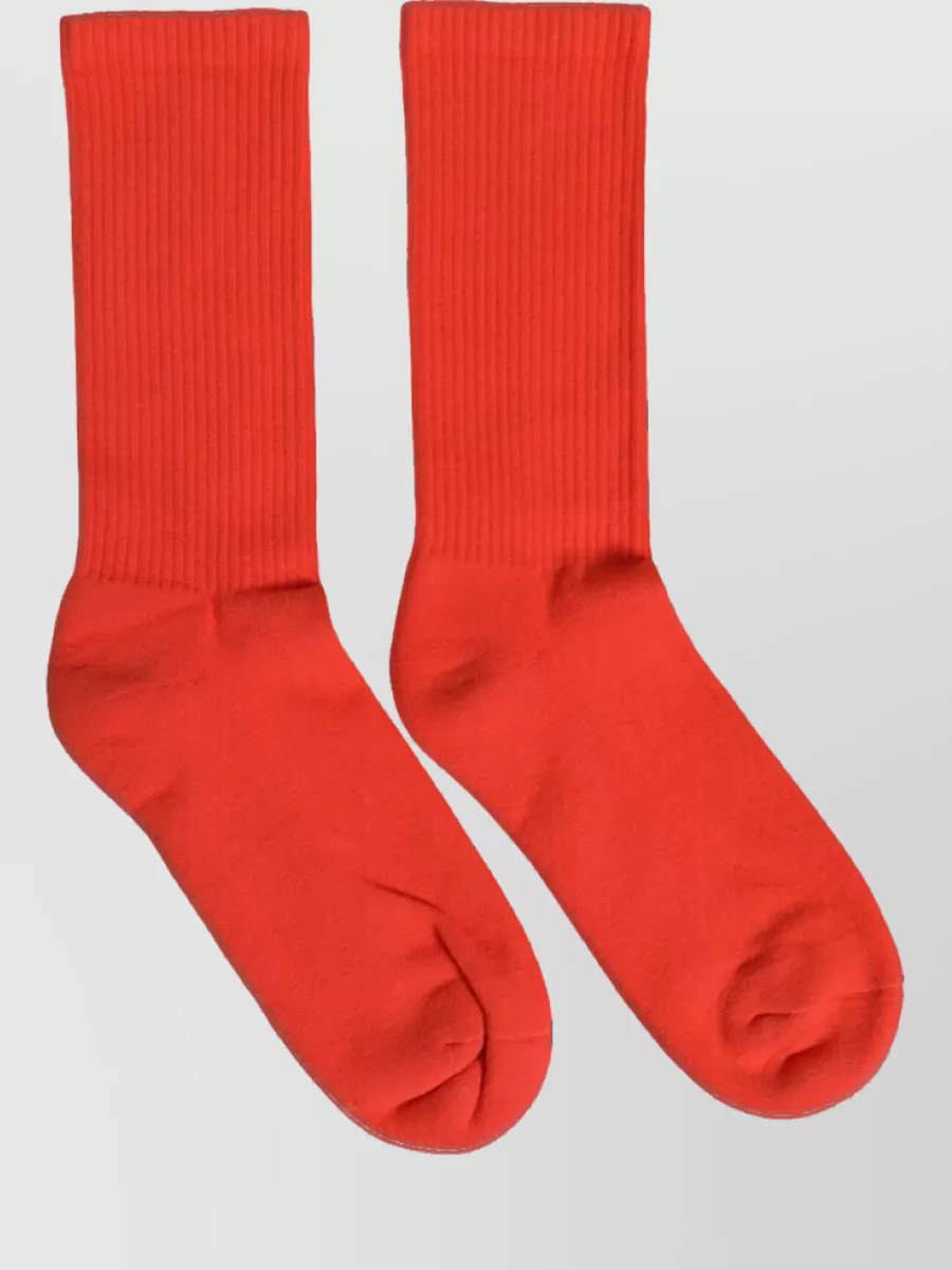 Dolce&Gabbana Cotton ribbed mid calf socks — The bright red Dolce&Gabbana socks give a sharp flash of colour between legging and sneaker, reinforcing the red story without adding bulk or clutter.
