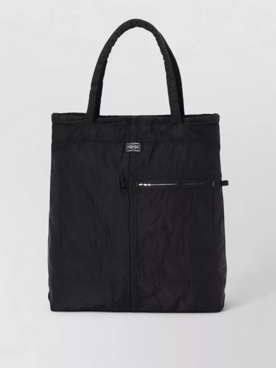 Porter Quilted tote bag — Porter’s structured black tote in F matches the technical, city-first vibe of the outfit and its clean nylon finish gives a subtle texture contrast while staying firmly in a minimalist lane.