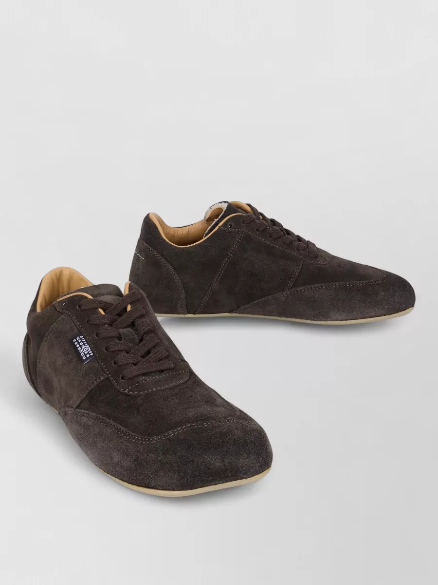 Mm6 Maison Margiela Suede calfskin lace-up shoes — The Mm6 dark chocolate suede lace-ups echo the sweatshirt’s rich brown palette in a slim, understated profile that supports the relaxed jogger silhouette without adding bulk or distracting branding.