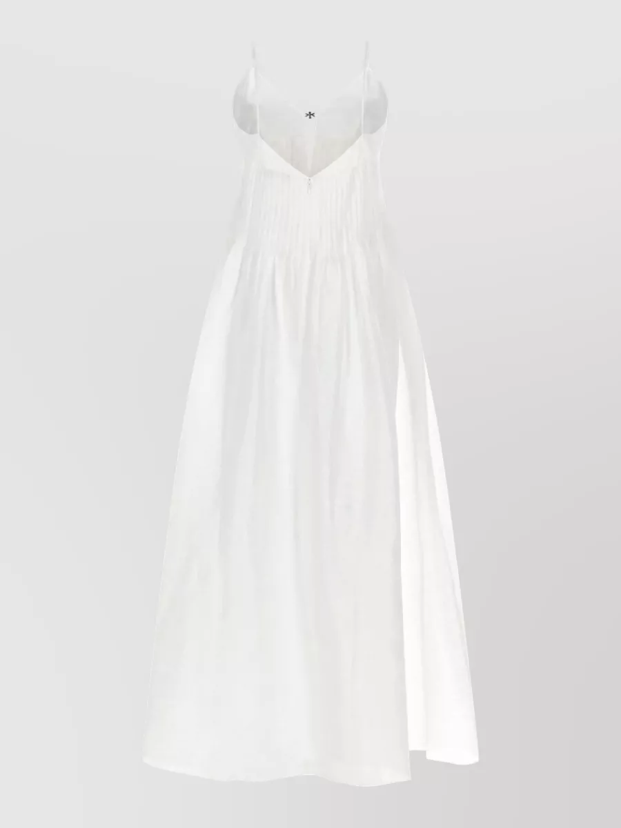 Tory Burch Linen maxi beach dress — The white Tory Burch pleated maxi mirrors the tote’s Riviera mood and neutral palette, creating a minimalist, beach-to-city column that feels harmonious without needing extra separates.