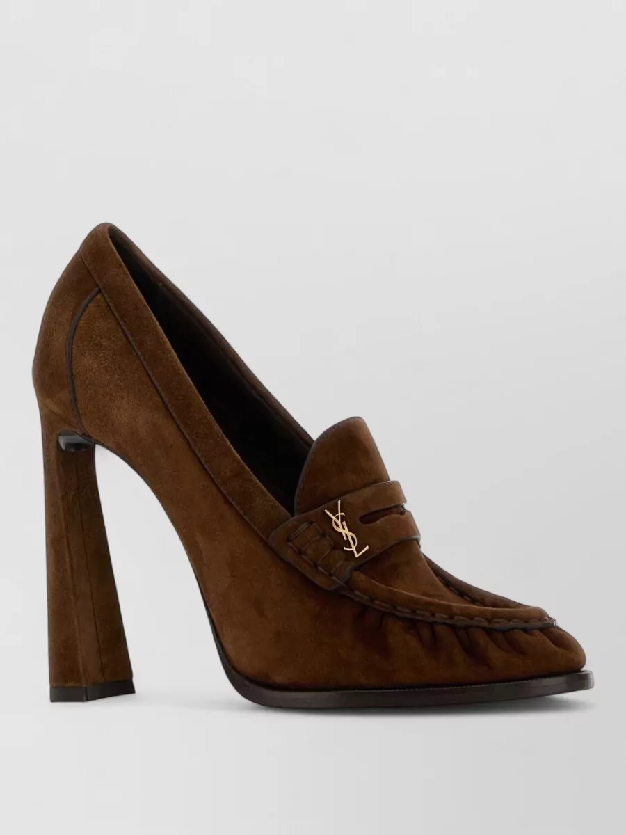 Saint Laurent Suede loafers — The caramel knee-high stiletto boots echo the coat’s length and warmth, reinforcing the long, polished line while keeping the neutral story tight and luxurious.
