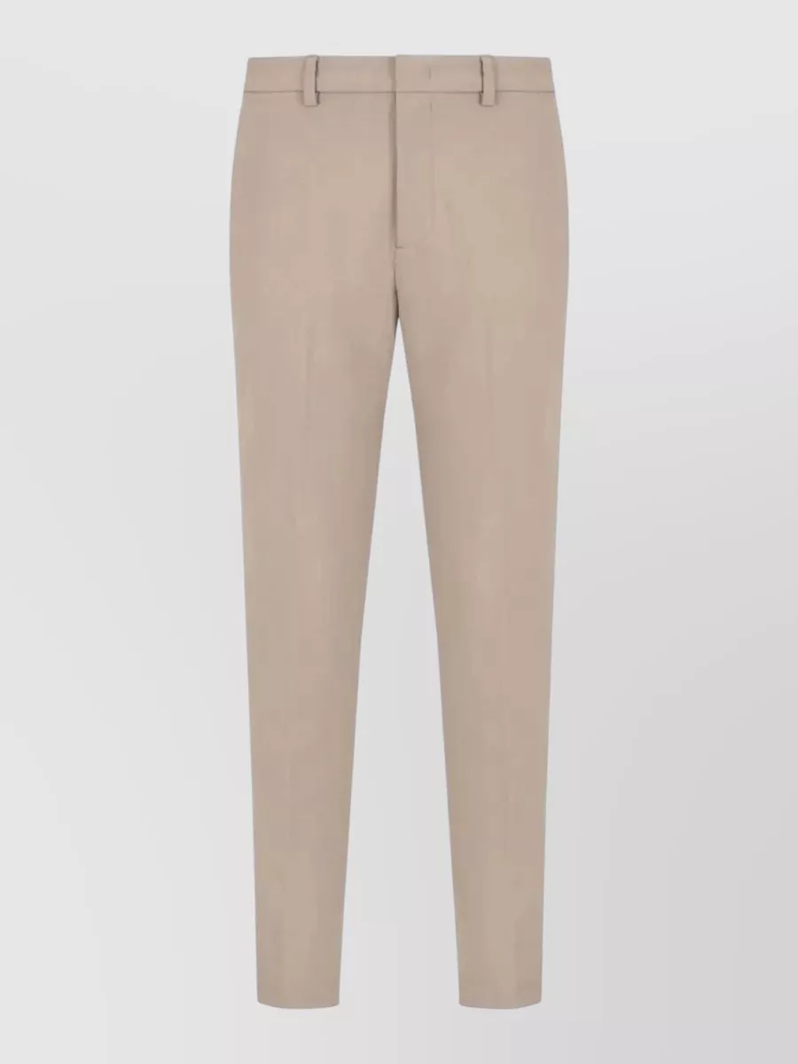 Emporio Armani Regular-fit straight-leg trousers — The Emporio Armani warm beige straight-leg trouser continues the quiet luxury neutral story of the tee while adding tailored polish and a clean, regular silhouette that matches the tee’s ease.