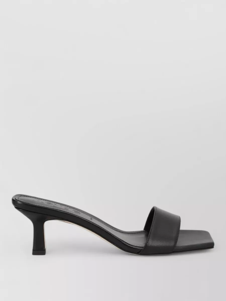 Aeyde Leather heeled mules — The Aeyde black square-toe kitten-heel mule keeps the profile clean and architectural, adds subtle height to balance the midi length, and matches the dress’s refined yet relaxed mood.
