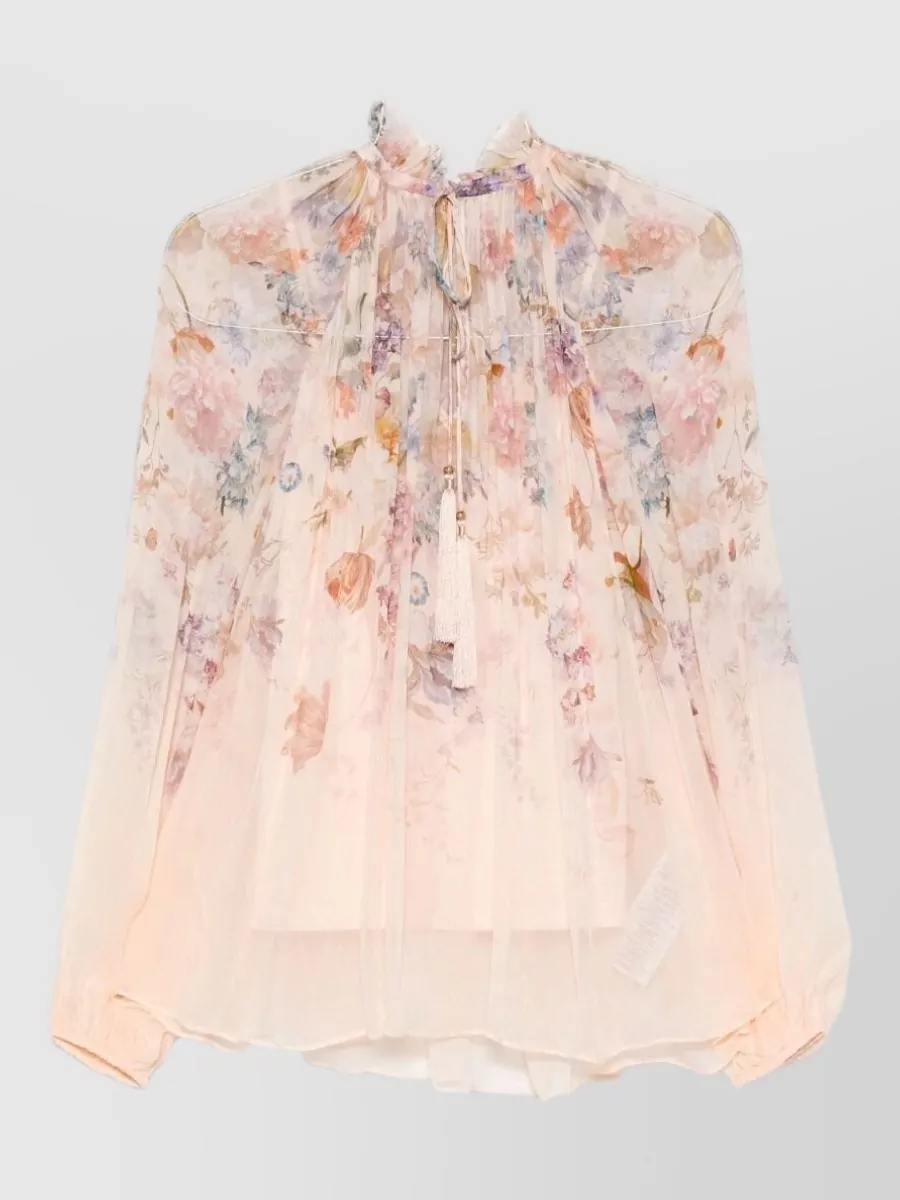 Zimmermann Valiant floral-print high-neck long-sleeve blouse — The Zimmermann sheer floral blouse in soft peach and lilac mirrors the skirt’s washed pastels and romantic mood while its light volume tucks cleanly into the high-waisted pleated midi.