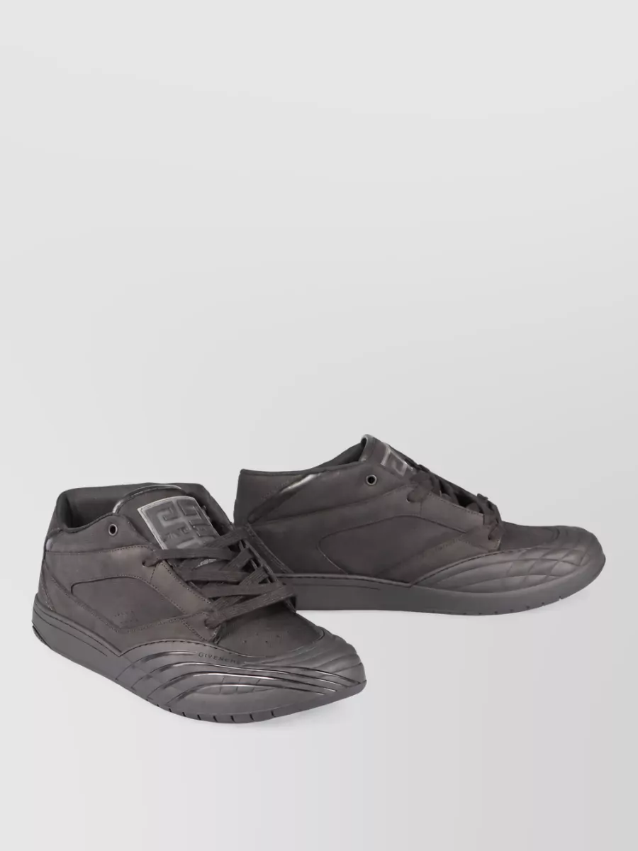 Givenchy Leather hi-top sneakers — Givenchy’s all-black sculpted sneakers echo the shirt’s modern geometry while keeping the base clean, technical and relaxed-formal enough to sit between tailoring and streetwear.