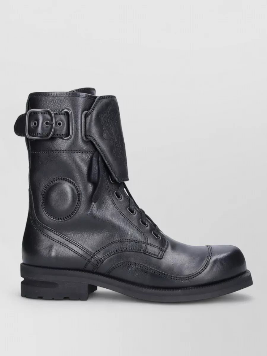 Kiko Kostadinov Leather ankle boots — The Kiko Kostadinov combat boot’s structured, technical edge reinforces the utility cargo and sits comfortably in the same luxury tier while the black leather grounds the outfit for colder weather.