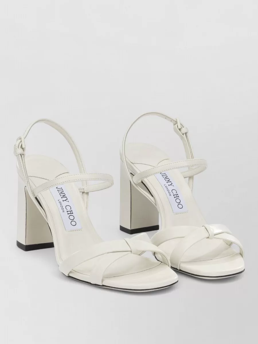 Jimmy Choo Leather elsy 85 heeled sandals — The Jimmy Choo ivory block-heel sandals echo the skirt’s softness in both color and polish, adding height and occasion-readiness while keeping the lines minimal and balanced with the mini length.