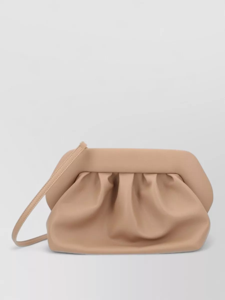 Themoiré bios clutch bag — The nude Themoiré pleated clutch keeps to the soft neutral story and sculptural lines, adding polish without drawing focus away from the twist detail of the dress.