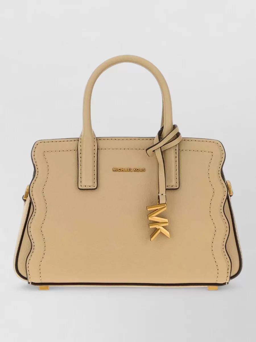 Michael Kors Na na leather mini bag — Pinko’s caramel quilted bag in I mirrors the warm camel tones of the skirt, adds soft structure and subtle gold hardware, and stays within the same polished yet approachable tier as the shoes.