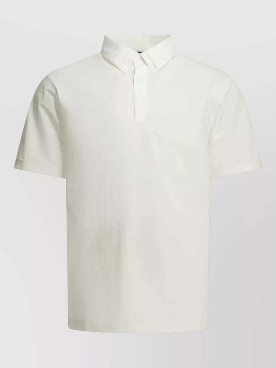 Oakley Seersucker polo shirt — The light grey-blue tee sits in the same cool spectrum as the seafoam shorts, keeping a clean technical mood while adding soft contrast instead of stark white.