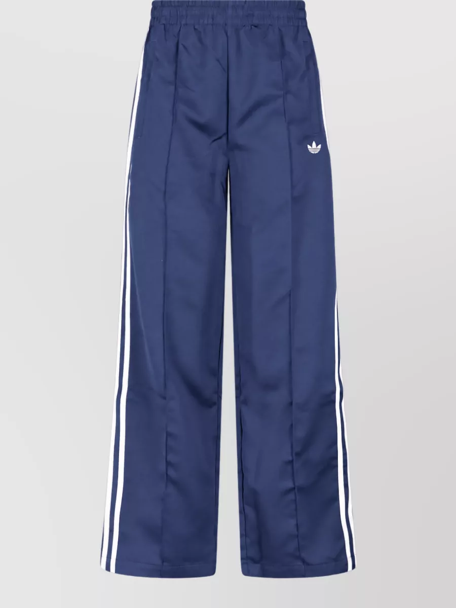 Adidas Straight track pants — The navy straight-leg track pants mirror the tee's navy trim for a clean, heritage-sport set that feels cohesive and season-right while keeping the silhouette relaxed rather than bodycon.