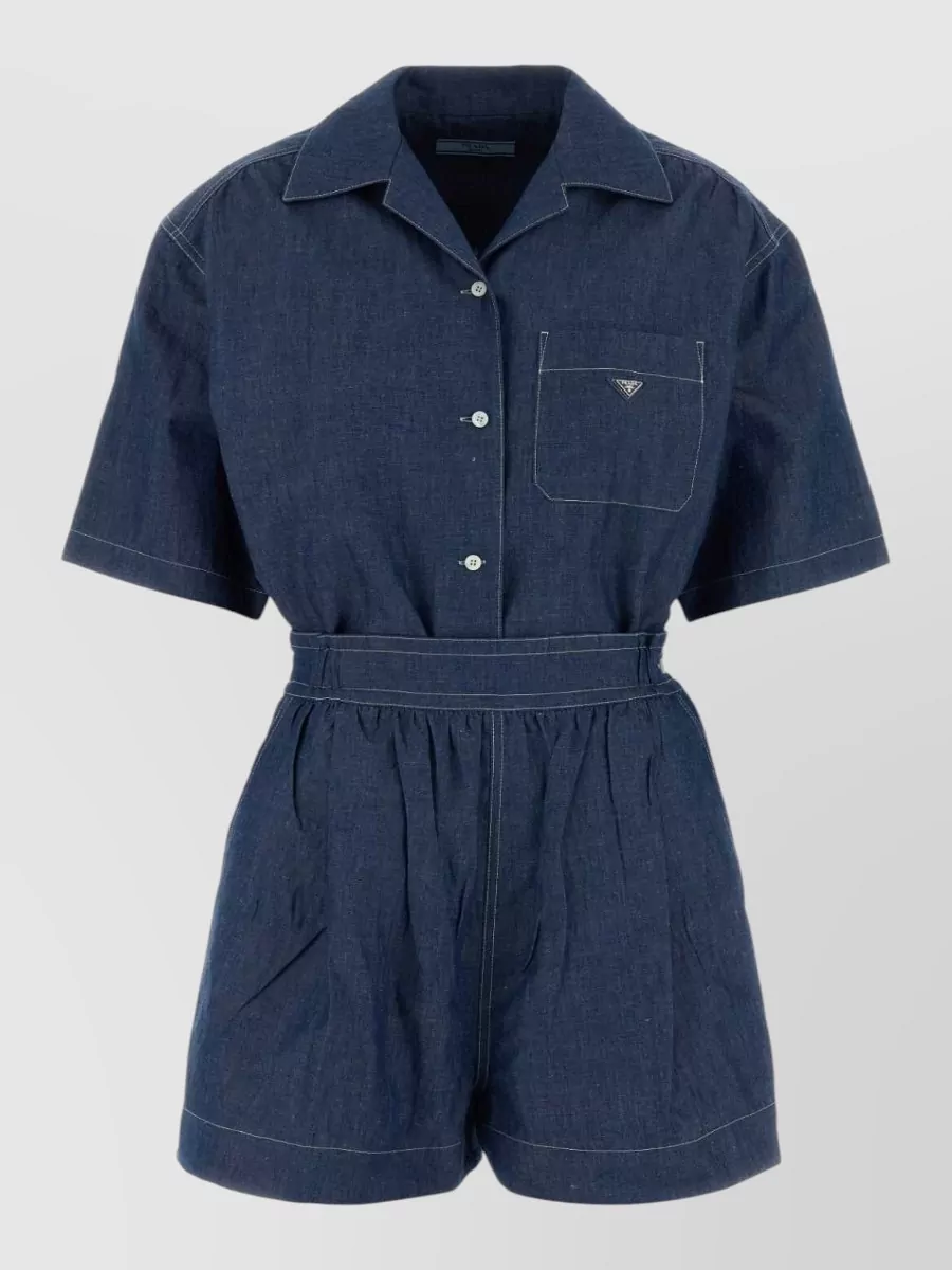 Prada Chambray jumpsuit — The ink‑navy bubble mini shift matches the bomber’s fabric language and color, giving a clean, sporty Prada set effect that feels sharper than pairing it with separate top and bottom.