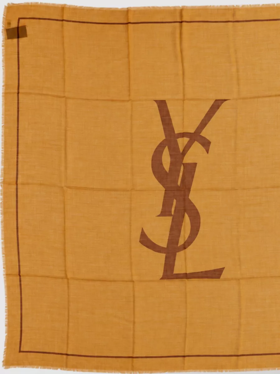 Saint Laurent Wool twill scarf — The Saint Laurent mustard-ochre scarf subtly echoes the shirt’s golden tone and can be worn or carried as an accent, enriching the color story without cluttering the clean lines.