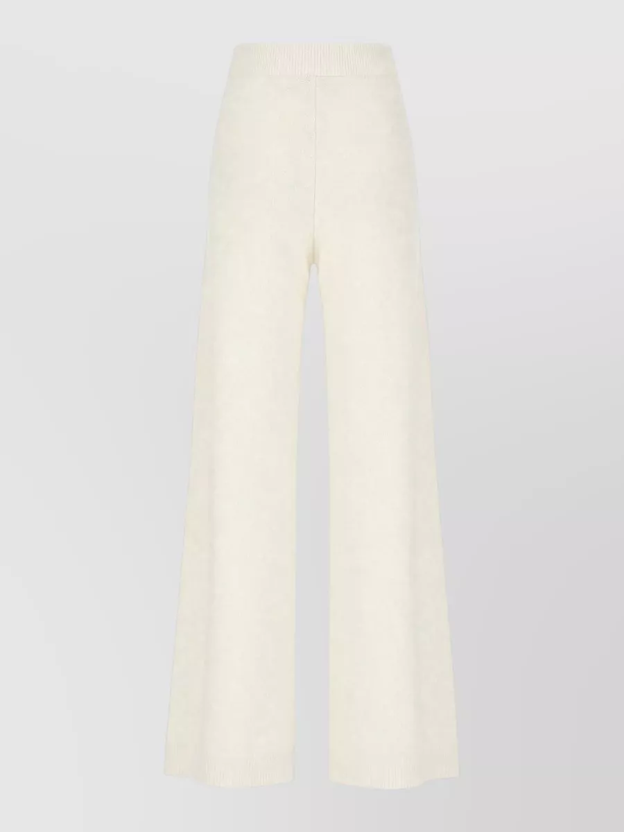 Fabiana Filippi Wool blend lounge pants — The Fabiana Filippi ivory wide-leg knit pant in a high waist mirrors the robe’s cocooning ease and palette, giving a clean, elongated line under the volume on top.