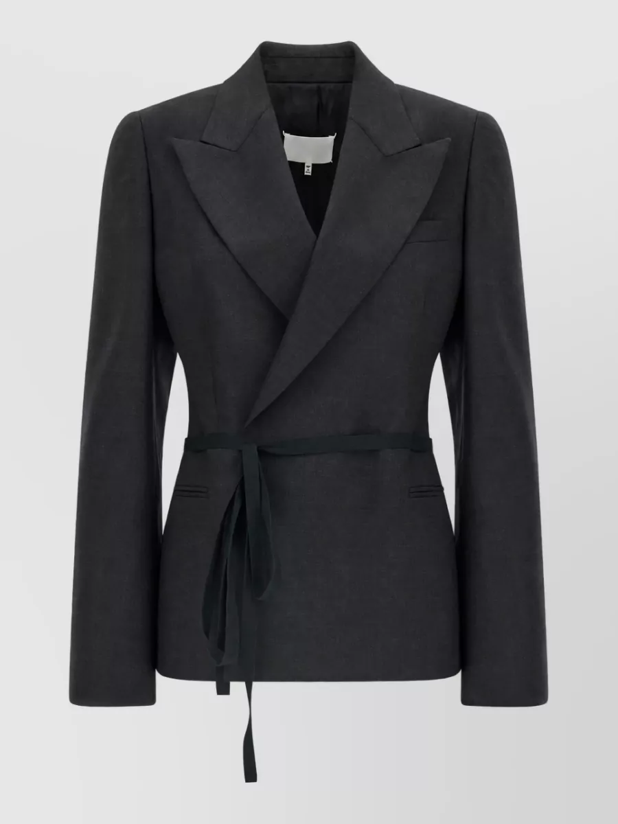 Maison Margiela Wool belted wrap blazer — The cinched Margiela tux blazer mirrors the trouser’s tailored sharpness while defining the waist, keeping the monochrome charcoal palette refined and boardroom-to-dinner ready.