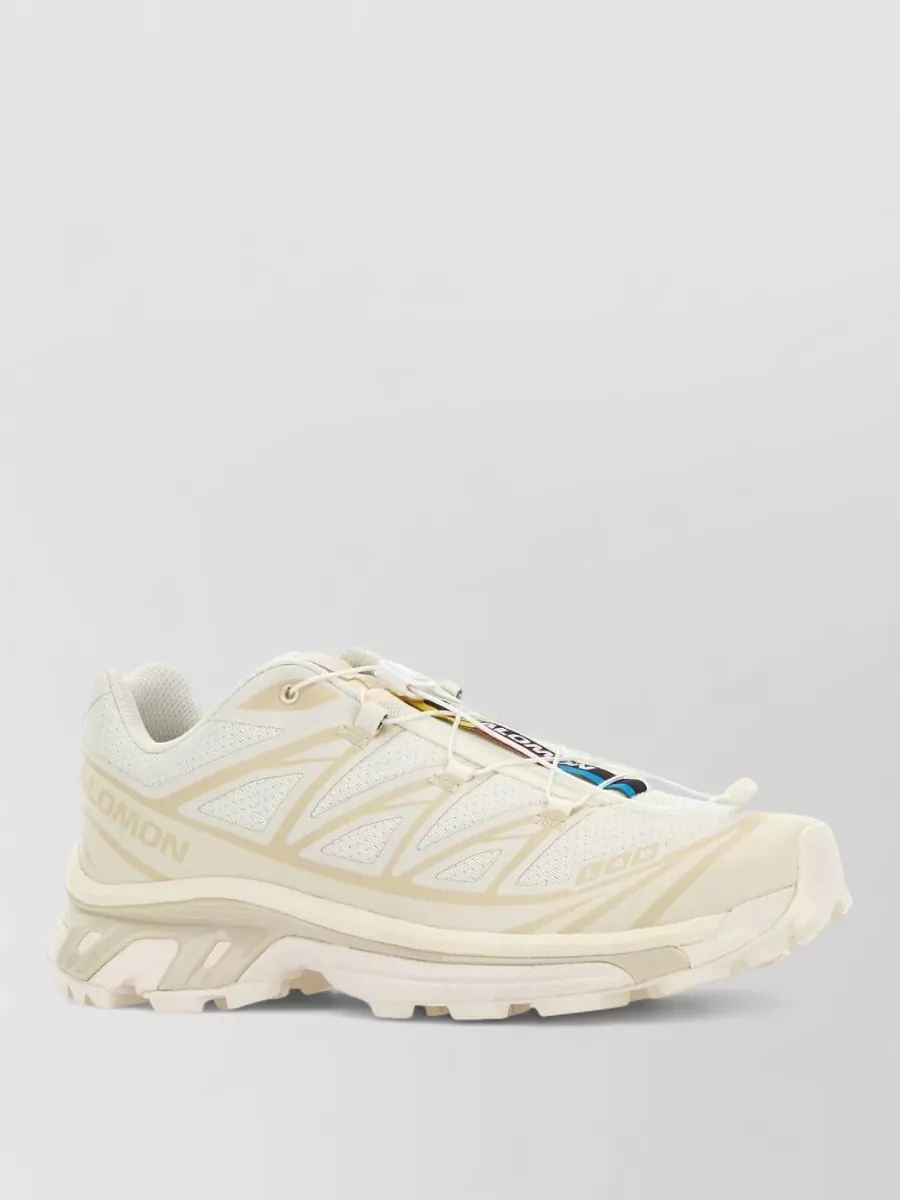 Salomon Fabric low-top sneakers — Cream Salomon runners mirror the beige tones of the socks and keep the outfit firmly in a refined athleisure space while staying neutral and quietly technical.