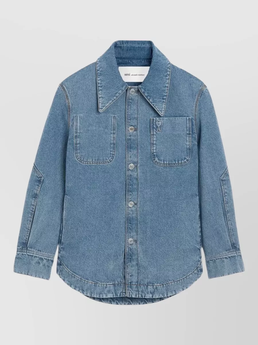 Ami Paris Denim shirt — The fitted white Acne tank lets the distressed short-sleeve denim jacket breathe, keeps the palette light and summery, and adds a sharp, athletic base under the boxy outerwear.