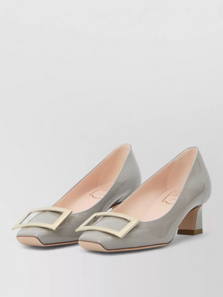 Roger Vivier Leather patent pumps — The dove‑grey low block‑heel pump feels quietly polished, harmonises with the cool blue shirt and navy trouser, and keeps the silhouette refined without adding visual noise.