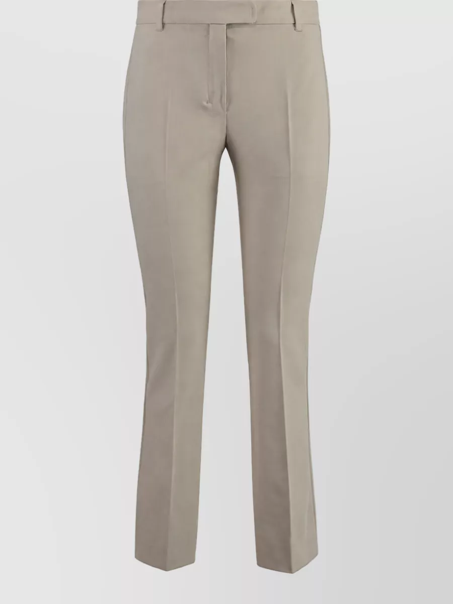 S Max Mara Flared suit trousers — The slim taupe trouser keeps the palette soft and minimal against the powder blue blazer, matching the tailored formality while gently grounding the color with a quiet neutral.