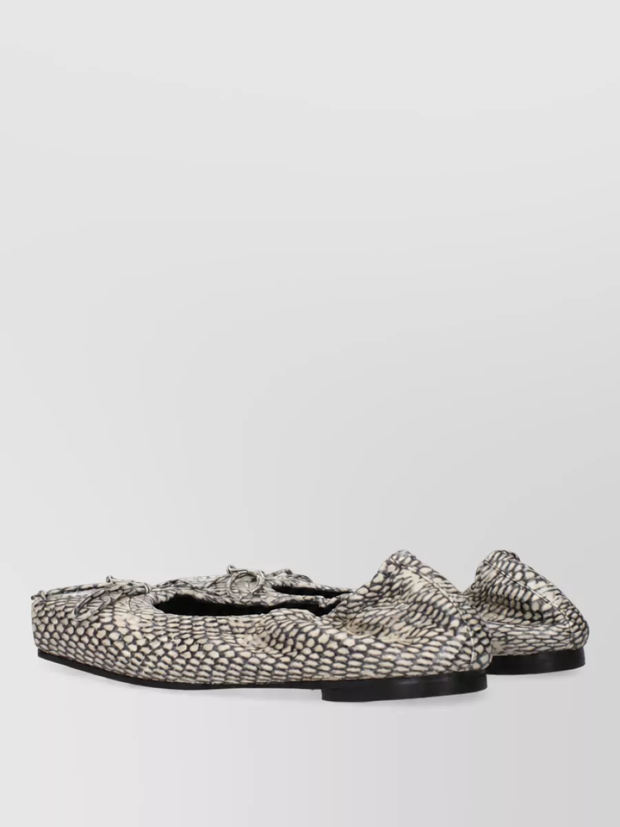 Jacquemus Leather loafers — The black Max Mara slingback sandals give a polished but easy finish that suits the trouser’s volume and formality while keeping the silhouette light at the hem.