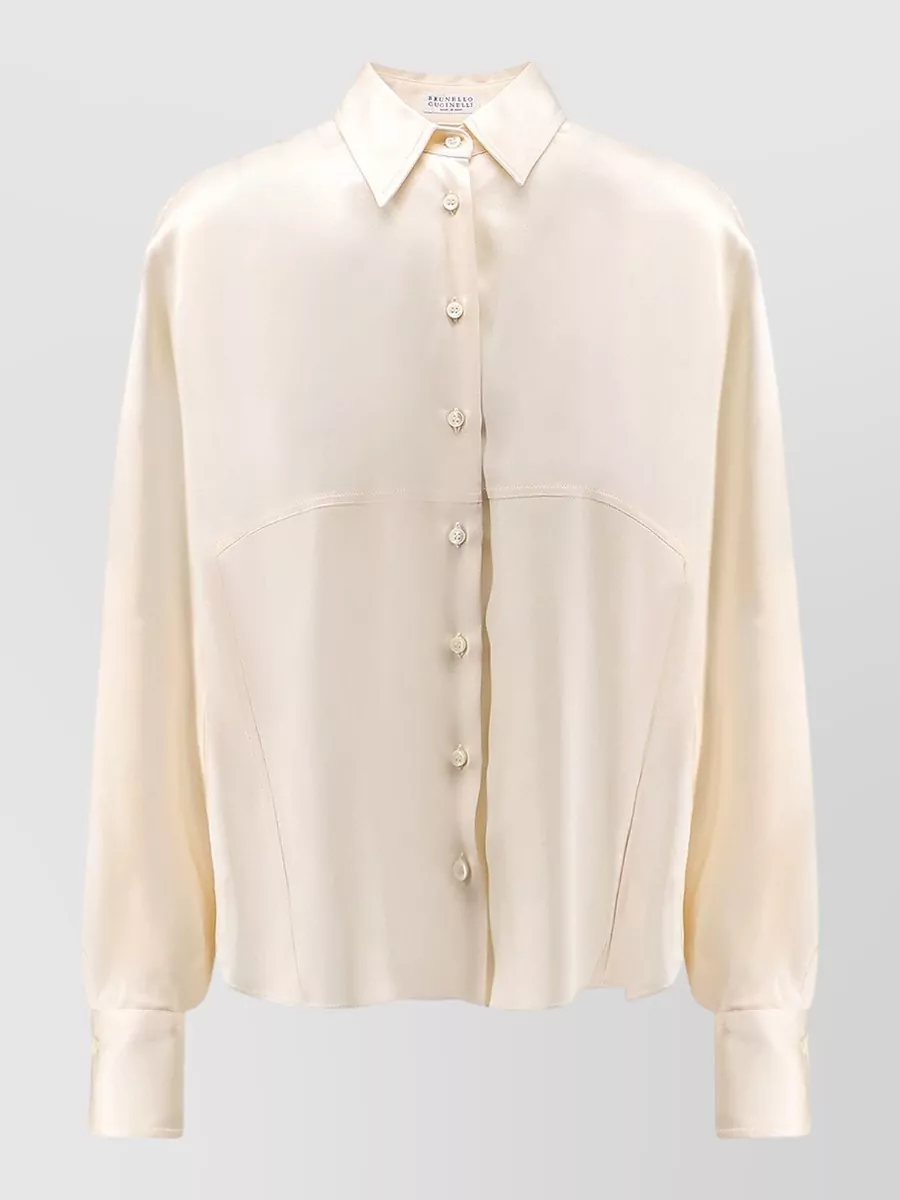 Brunello Cucinelli Silk long-sleeve shirt — The buttercream silk shirt keeps the outfit firmly in Brunello Cucinelli’s quiet-luxury lane, its soft warmth pairing beautifully with the deep brown trouser for refined office polish without competing in structure.