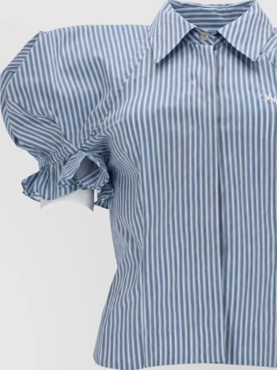 Vivienne Westwood Cotton blouse — The matching Vivienne Westwood striped puff-sleeve shirt mirrors the skirt’s soft blue pinstripes and tailored-preppy mood, creating a cohesive, directional co-ord that still feels light for warm weather.
