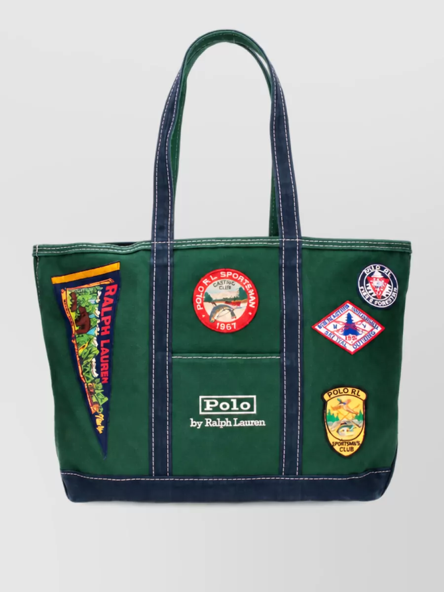 Polo Ralph Lauren Canvas beach bag — The Polo heritage canvas tote leans into the same varsity narrative as the rugby, adding forest green and patches for a confident sport-club accent that still sits in the same price tier.