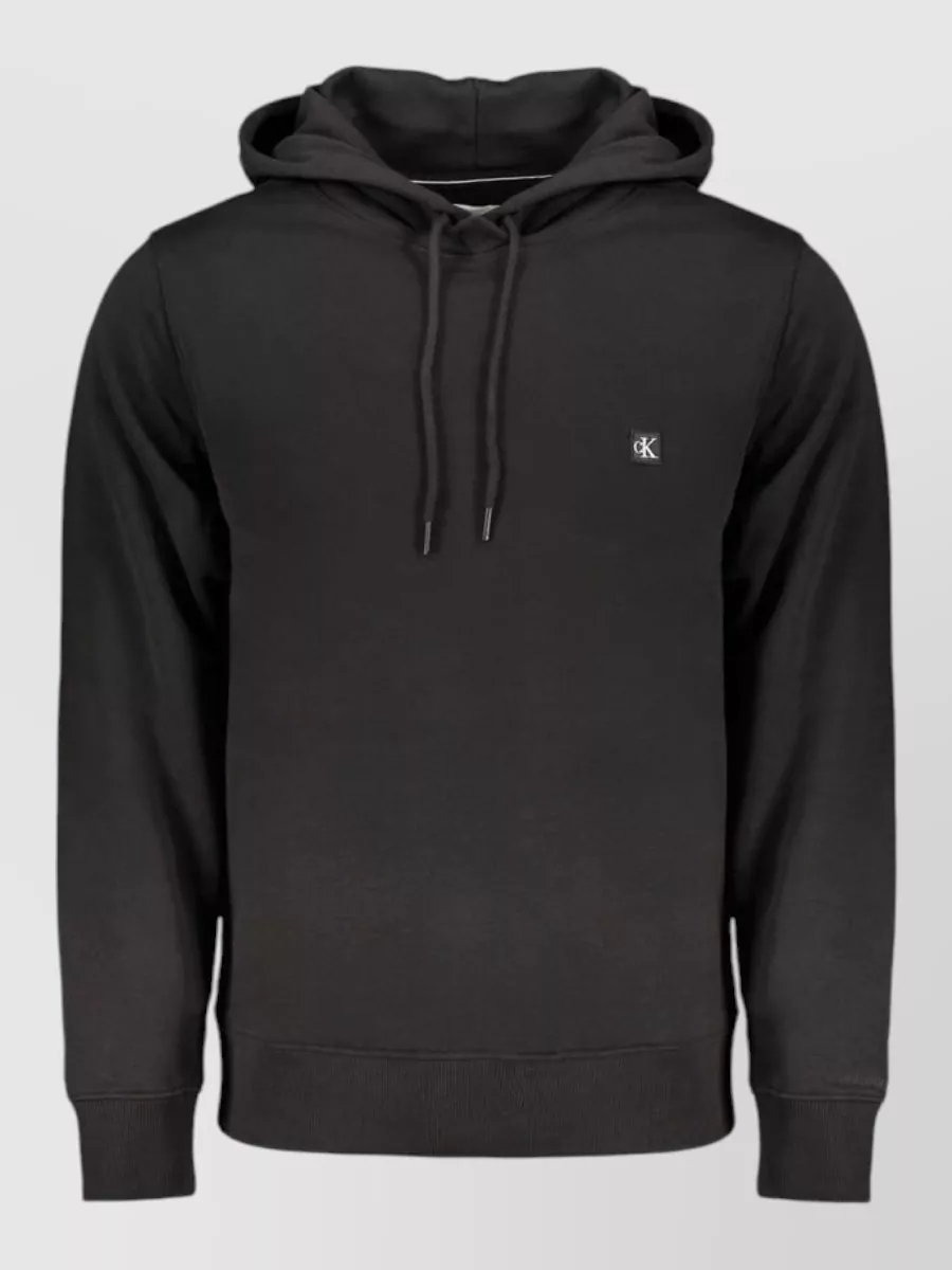 Calvin Klein Cotton sweatshirt — The Calvin Klein charcoal hoodie B mirrors the parka’s charcoal tone for a tight monochrome palette and easy layering without competing branding or bulk.