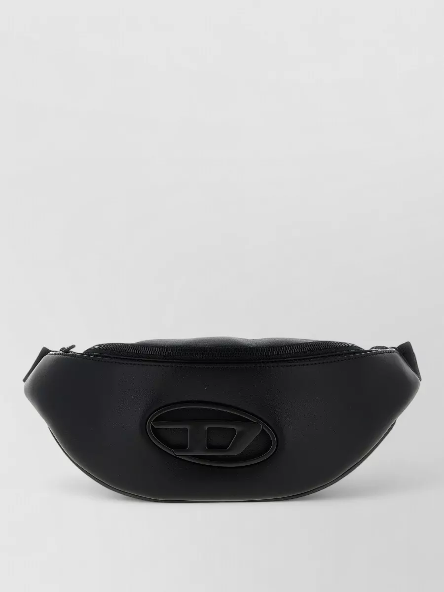 Diesel Leather belt bag — The compact black Diesel belt bag mirrors the jacket’s minimal branding and streetwear mood, adding utility without crowding the silhouette or competing with the olive tones.