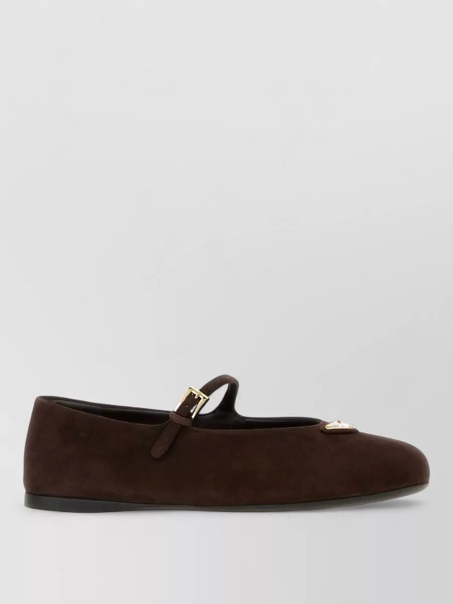 Prada Suede ballerina flats — The dark chocolate Prada Mary Jane flat leans collegiate and polished, harmonising with the camel argyle dress and checked bag while keeping the overall preppy tone grounded and wearable for day.
