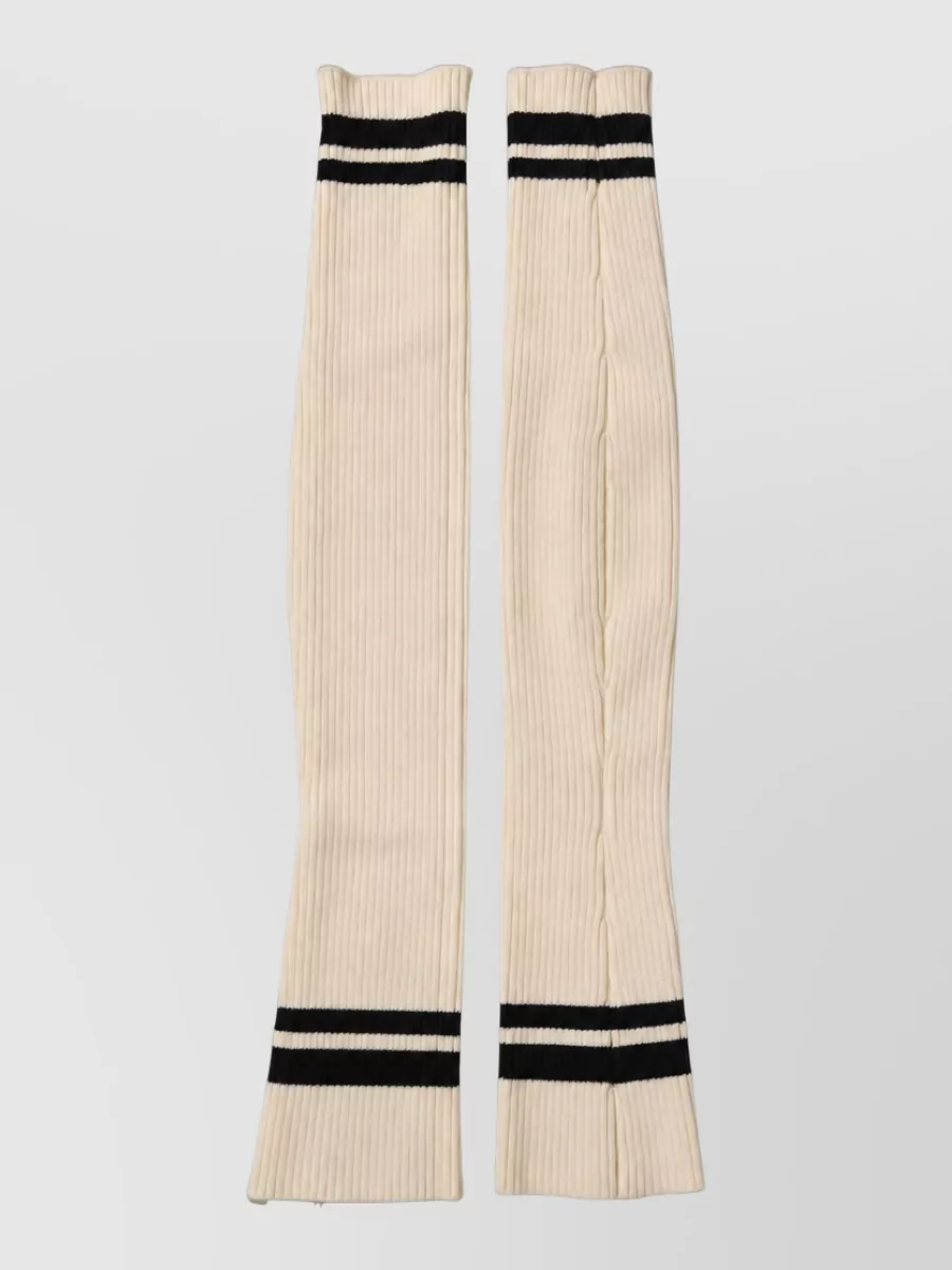 Dolce&Gabbana Wool thigh-high leg warmers — The cropped off-white Calvin Klein sweatshirt sits perfectly with branded sport socks for a modern athleisure mood, mirroring the monochrome palette and casual formality.