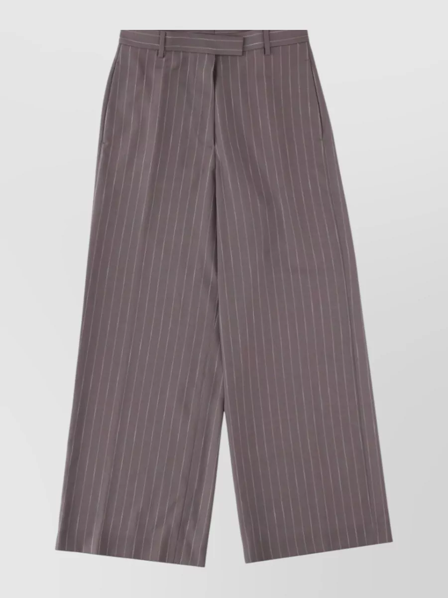 Dries Van Noten Wide leg trousers — B is clearly the matching Dries Van Noten pinstripe trouser, giving a precise, elongated column in the same taupe-grey story for a true minimalist pantsuit.