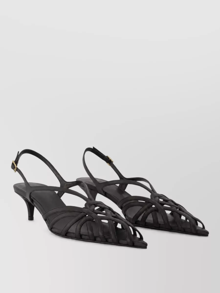 Balmain Leather kitten heel mules — The black strappy pointed kitten-heel slingback is refined yet walkable, echoing the tee’s understated gold detail while keeping the overall silhouette sleek rather than overtly dramatic.