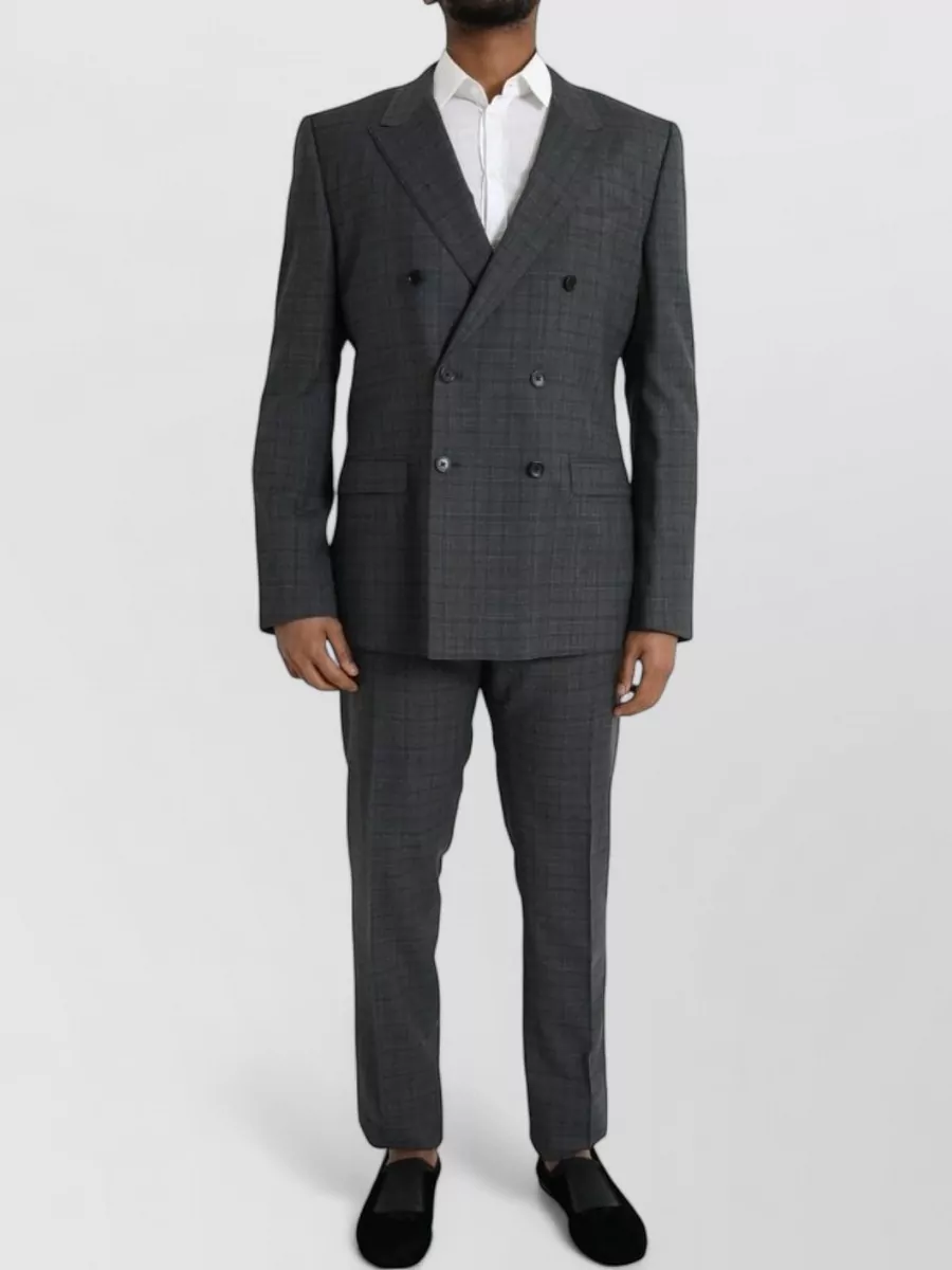 Dolce&Gabbana Checked double-breasted suit — The charcoal double-breasted checked jacket mirrors the source coat’s tailored, preppy grid while keeping the palette soft and structured underneath the graphic outer layer.