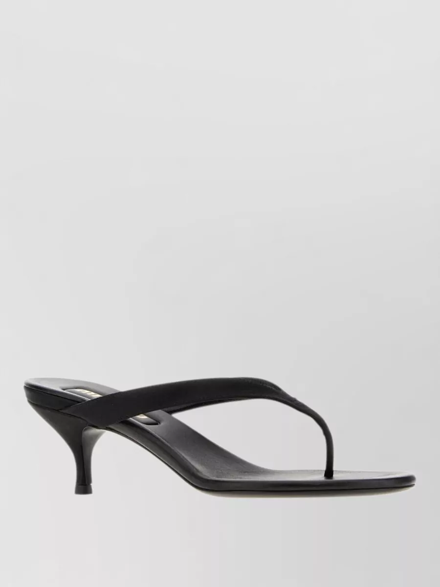 Miu Miu Satin thong sandals — Miu Miu’s black thong kitten-heel mule F nods to late‑’90s Y2K, keeps the silhouette light with the mini hem, and ties seamlessly into the Prada bag’s sleek black-and-gold palette.
