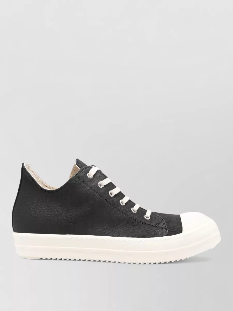 Rick Owens Drkshdw Denim low-top sneakers — Chunky black and off-white DRKSHDW low-tops ground the elongated trench and drop-crotch pant with a graphic, platformed base that feels very Rick on the streetwear axis.