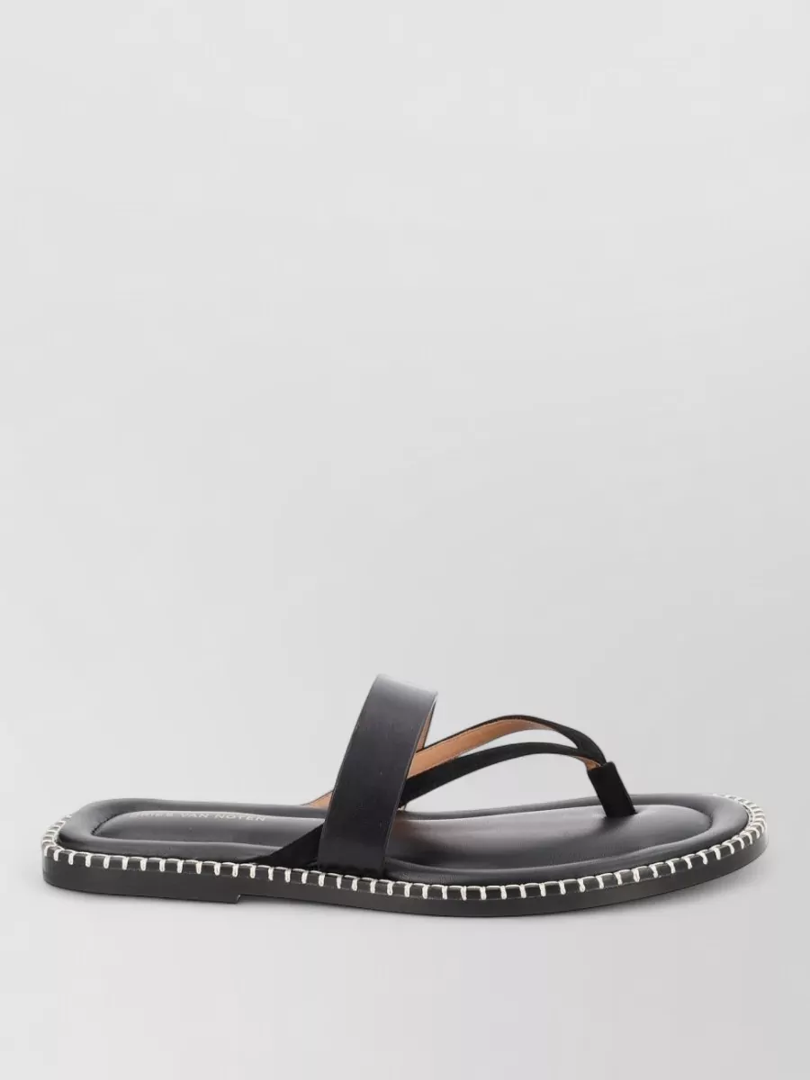 Dries Van Noten Leather slides — The sleek black thong slide mirrors the shirt’s ease, ties into the black short, and keeps the outfit firmly in sophisticated warm-weather territory.
