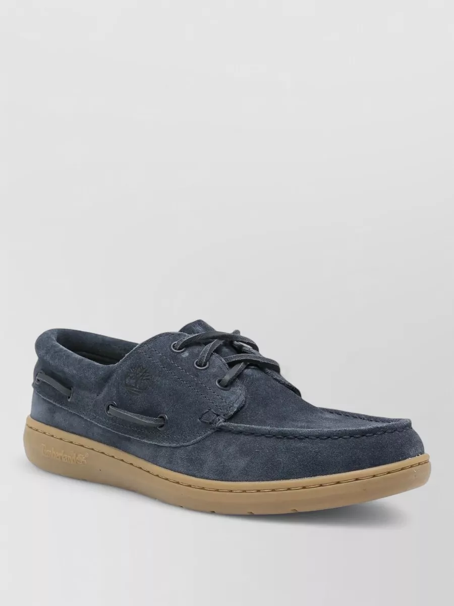 Timberland Boat shoes — The smoky navy suede boat shoes echo the short’s tone while the sand gum sole softens the overall effect, delivering a polished deck-shoe finish that suits both city strolls and seaside plans.