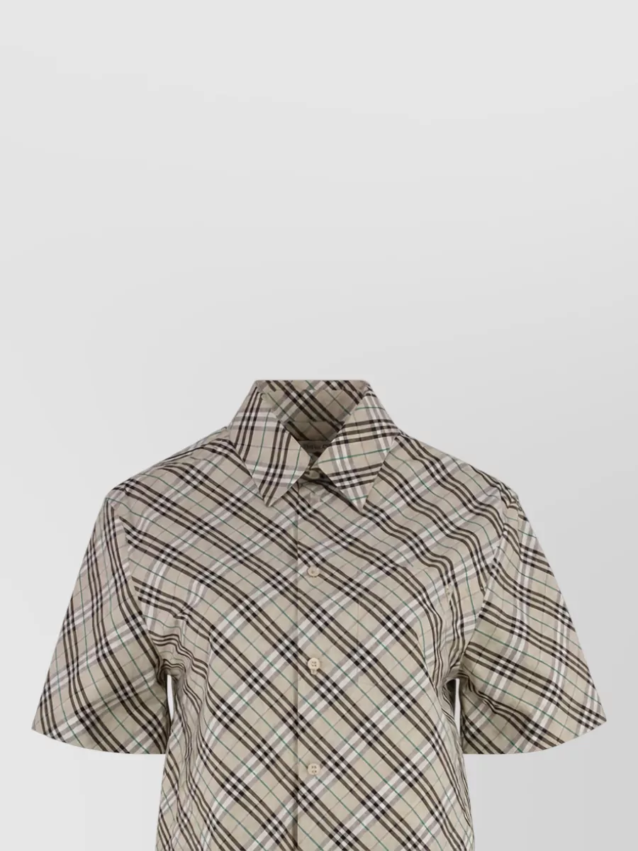 Burberry Checked cotton shirt — The short-sleeve diagonal-check shirt in similar beige and brown keeps the pattern play cohesive with the trousers while the cropped sleeve and lighter handle feel right for warm-weather polish.