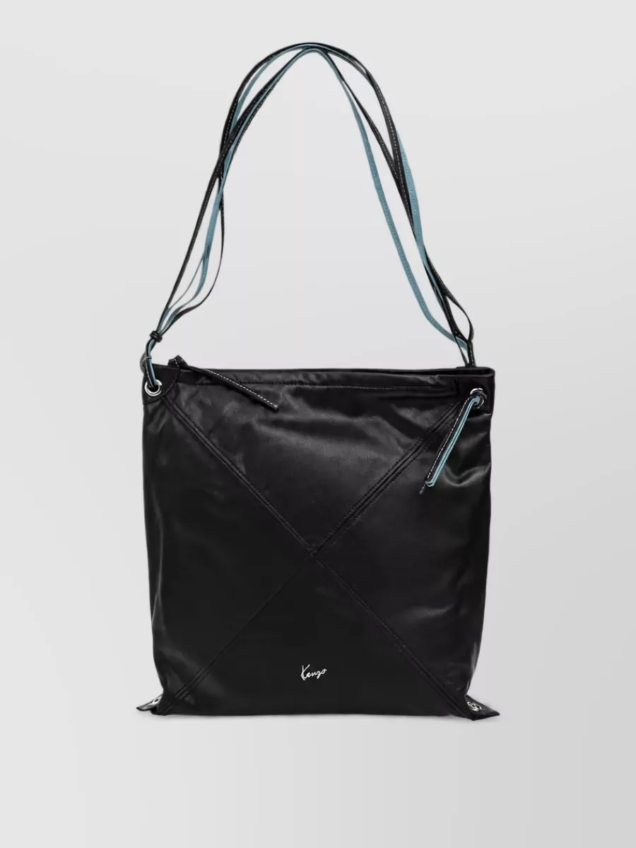 Kenzo kenzo logo leather shoulder bag — The black Kenzo shoulder bag with subtle ice blue detail echoes the tee’s softness and keeps the outfit logo-aware yet minimal, proportionally balancing the volume of the wide-leg denim.